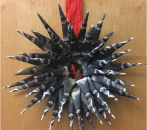 Paper wreath with a voice recorder as a centerpiece.